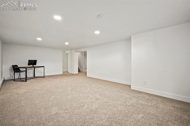 carpeted spare room featuring baseboards, stairway, and recessed lighting