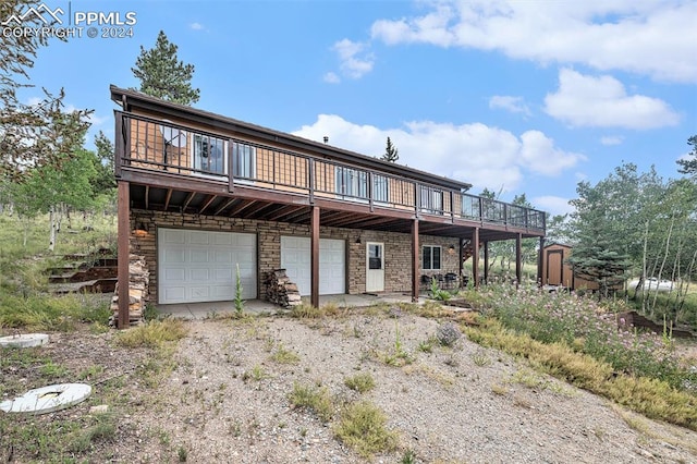 view of front facade with a garage and a deck