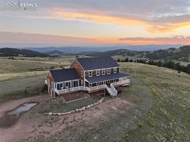 aerial view at dusk featuring a rural view