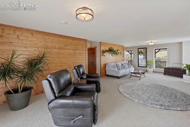 living room with wood walls and carpet floors