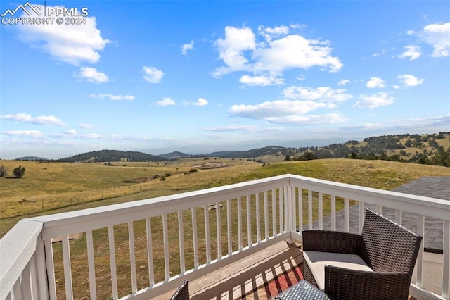 wooden terrace featuring a rural view