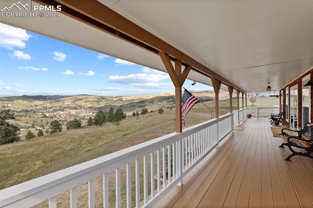 wooden terrace featuring a rural view