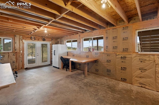 basement with white refrigerator and french doors