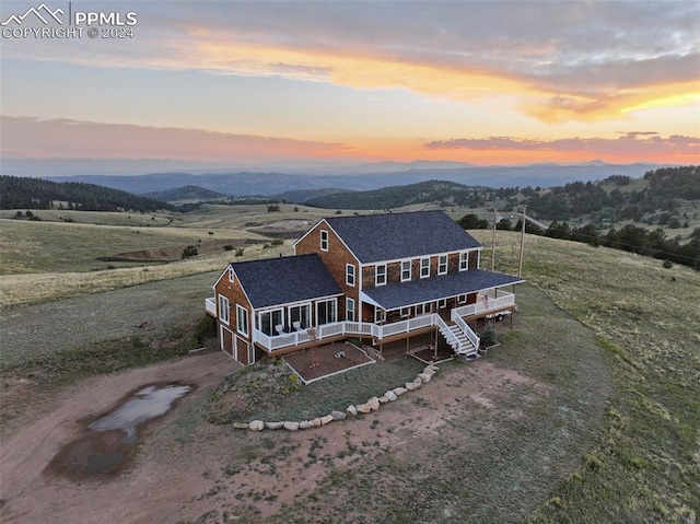 aerial view at dusk featuring a rural view