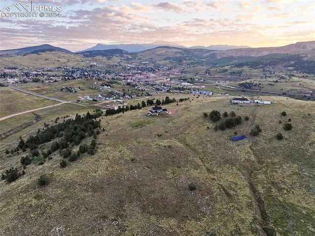 aerial view at dusk with a rural view and a mountain view