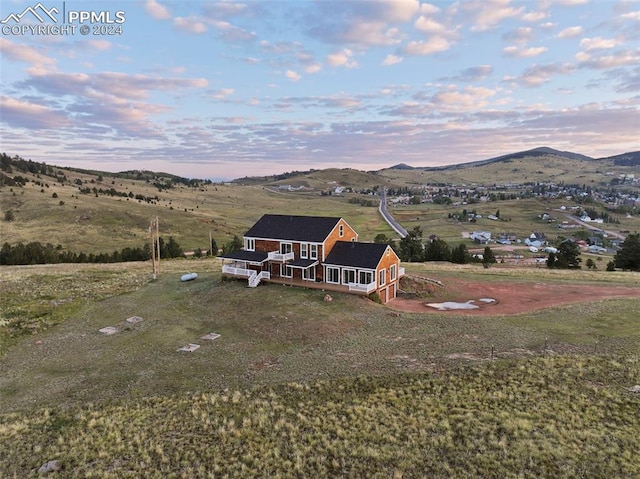 aerial view at dusk with a rural view and a mountain view