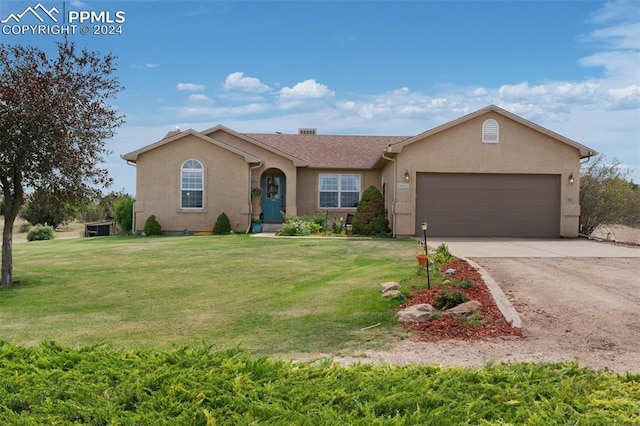 single story home featuring a garage and a front lawn