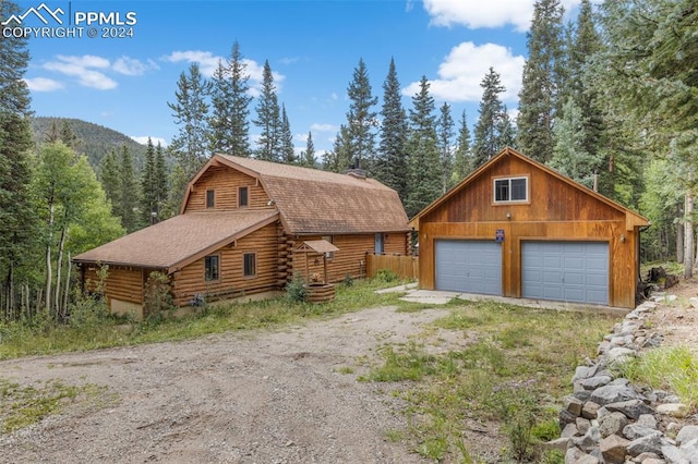 log cabin with an outbuilding and a garage