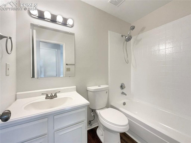 full bathroom featuring tiled shower / bath combo, vanity, toilet, and hardwood / wood-style flooring