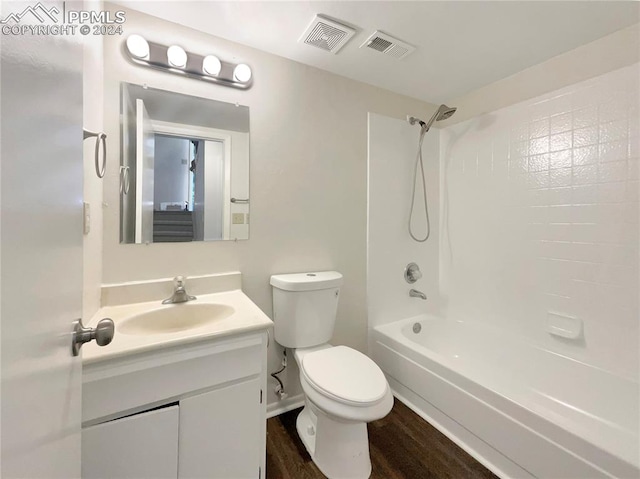 full bathroom with vanity, toilet, wood-type flooring, and bathing tub / shower combination