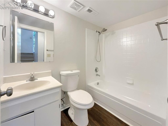 full bathroom featuring wood-type flooring, toilet, tub / shower combination, and vanity