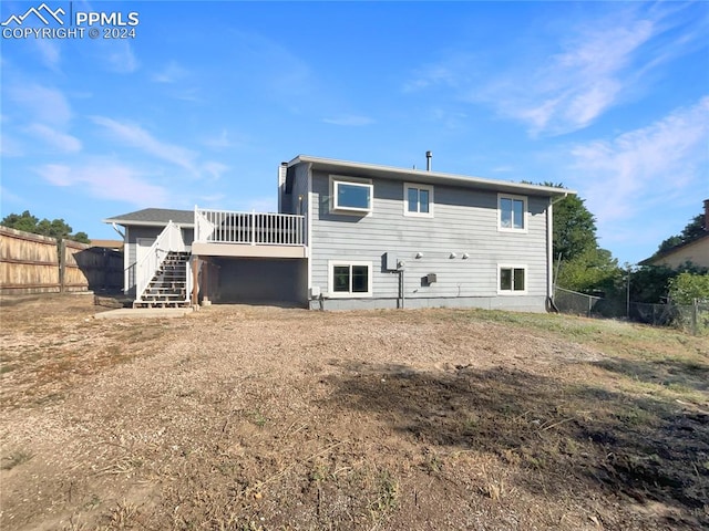 back of house featuring a deck