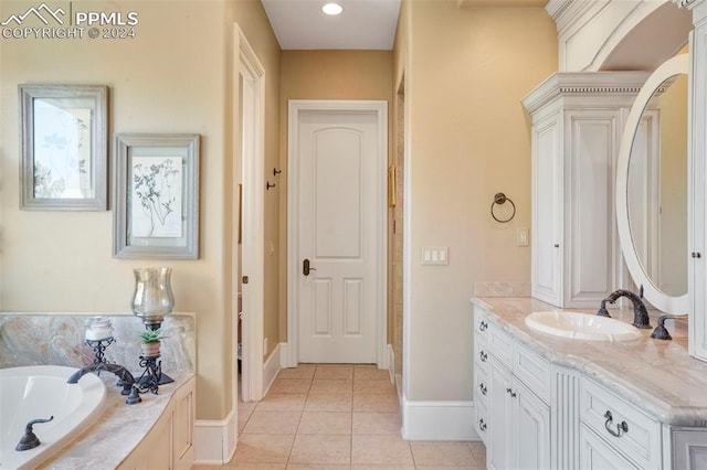 bathroom with tile patterned floors, a washtub, and vanity