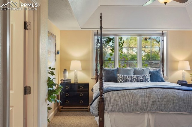 carpeted bedroom with vaulted ceiling and ceiling fan