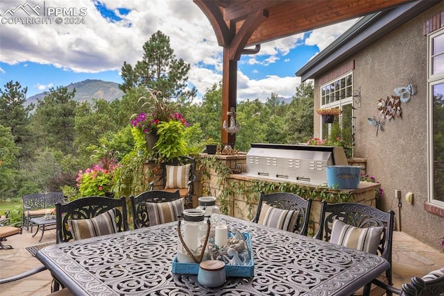 view of patio / terrace featuring a mountain view, grilling area, and area for grilling