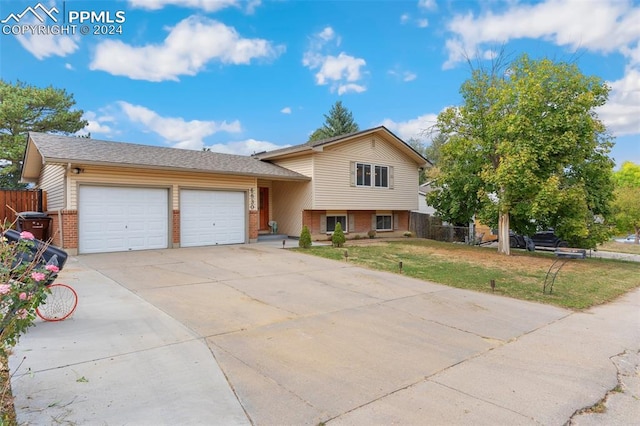 split level home featuring a front yard and a garage