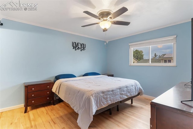 bedroom featuring crown molding, baseboards, ceiling fan, and wood finished floors