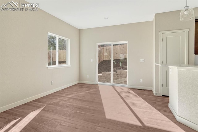 unfurnished room featuring wood finished floors and baseboards