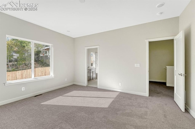 unfurnished bedroom featuring carpet, visible vents, and baseboards