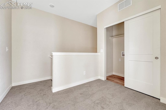 unfurnished bedroom featuring carpet floors, baseboards, visible vents, and a closet