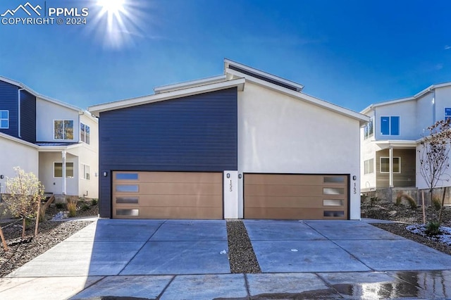 view of front facade with concrete driveway and stucco siding