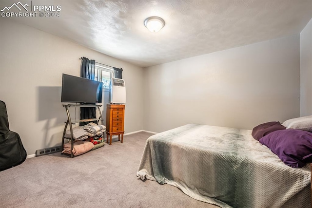 carpeted bedroom featuring a textured ceiling