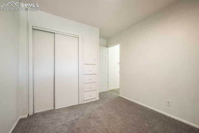 unfurnished bedroom featuring a closet and carpet