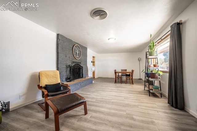 sitting room featuring a fireplace and light hardwood / wood-style floors