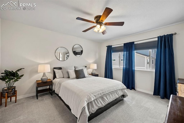 bedroom featuring ceiling fan and light colored carpet