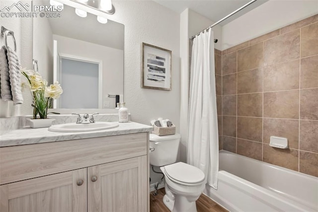 full bathroom with vanity, toilet, wood-type flooring, and shower / bathtub combination with curtain