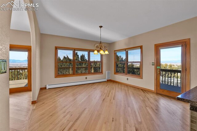 kitchen featuring a breakfast bar area, light hardwood / wood-style flooring, a notable chandelier, a center island, and stainless steel appliances