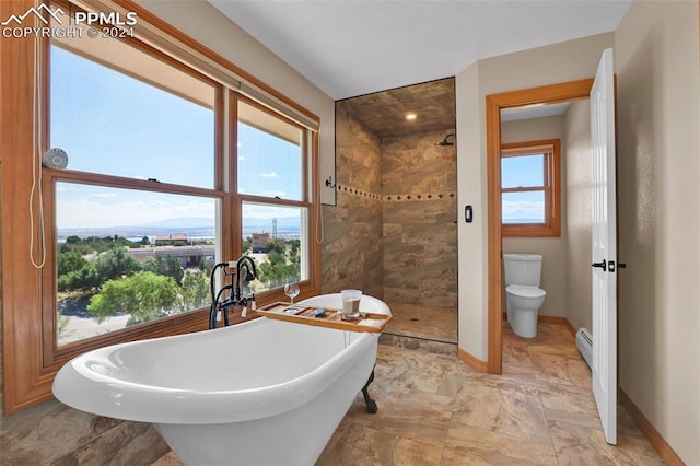 bathroom featuring baseboard heating, separate shower and tub, and toilet