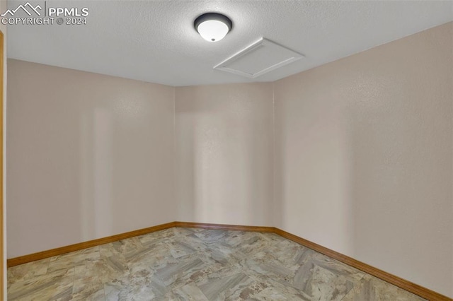 empty room featuring a textured ceiling