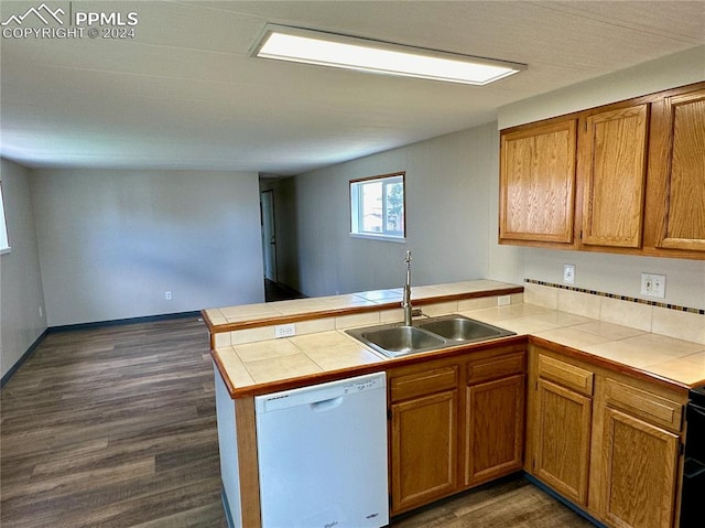 kitchen with dishwasher, kitchen peninsula, sink, and tile counters