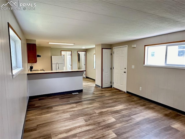 interior space with wood walls and hardwood / wood-style floors