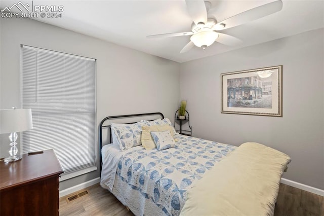 bedroom with wood-type flooring and ceiling fan