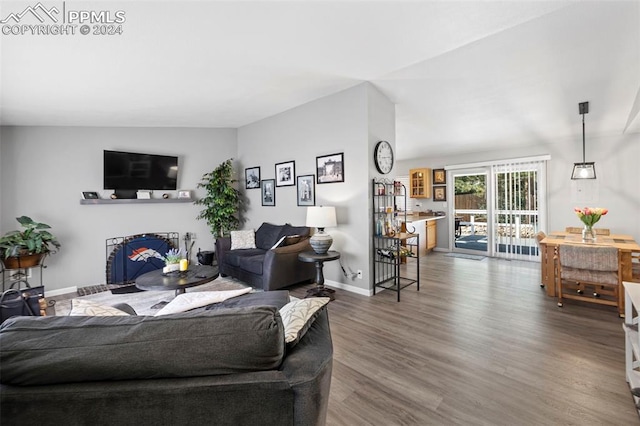 living room with lofted ceiling and hardwood / wood-style floors