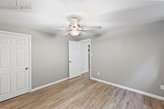 interior space with ceiling fan and light hardwood / wood-style floors