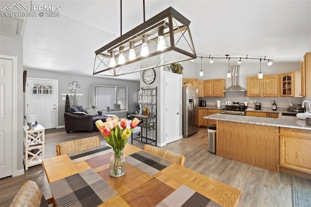 dining room with lofted ceiling and light wood-type flooring