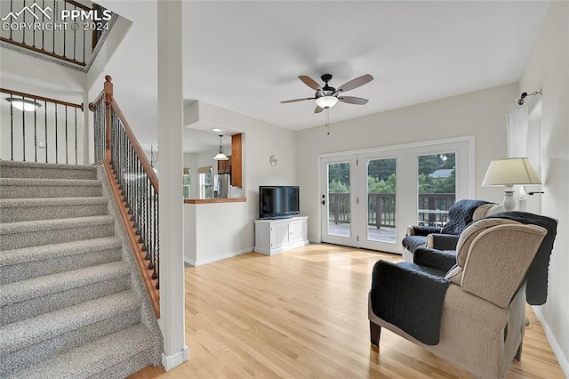 living room featuring ceiling fan and light hardwood / wood-style floors