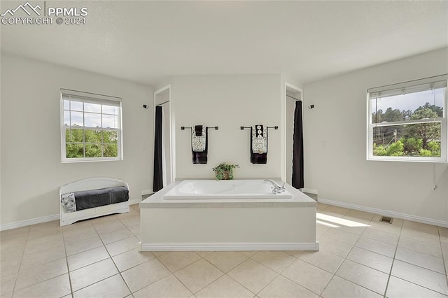 bathroom with a bathtub and tile patterned floors