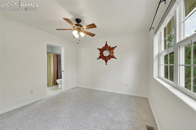 unfurnished room featuring light carpet and ceiling fan