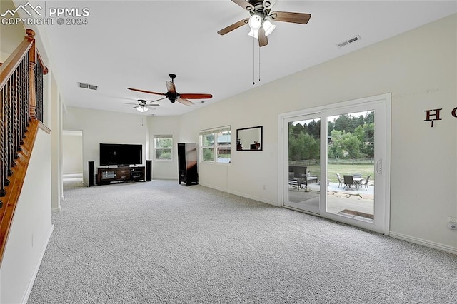 unfurnished living room featuring ceiling fan and carpet