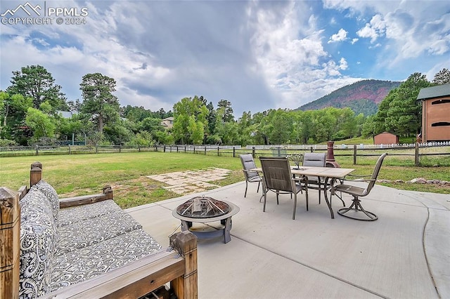 view of patio featuring a mountain view and an outdoor fire pit