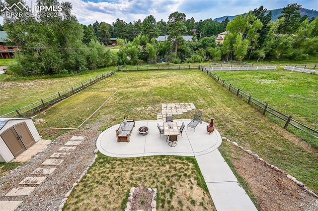 view of yard with a patio area and an outdoor fire pit