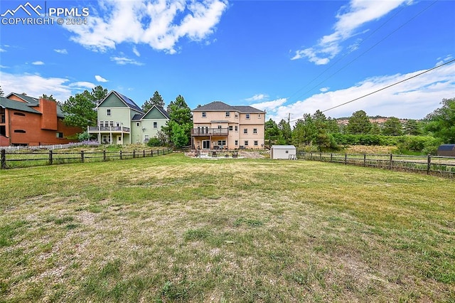 view of yard featuring a storage shed and a wooden deck