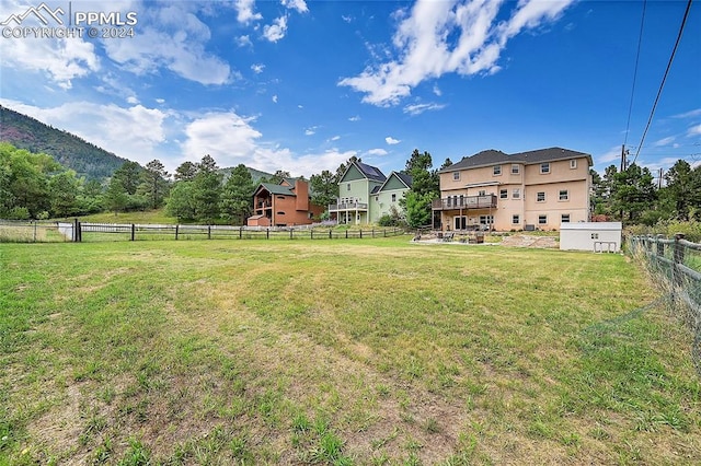 view of yard with a rural view and a deck