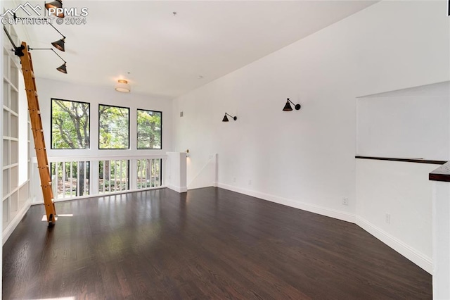 empty room with dark hardwood / wood-style floors