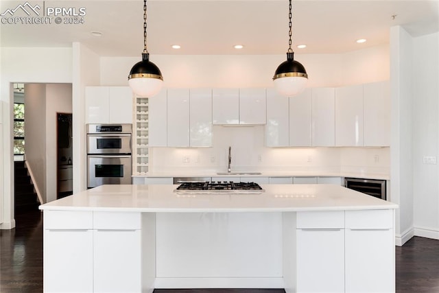 kitchen with a center island, decorative light fixtures, and white cabinets