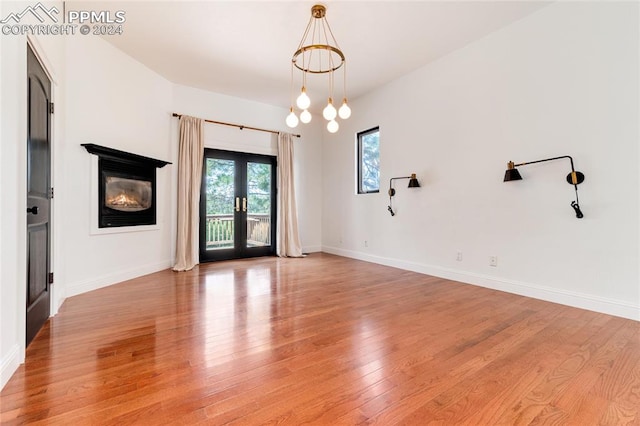 empty room with french doors and light hardwood / wood-style floors